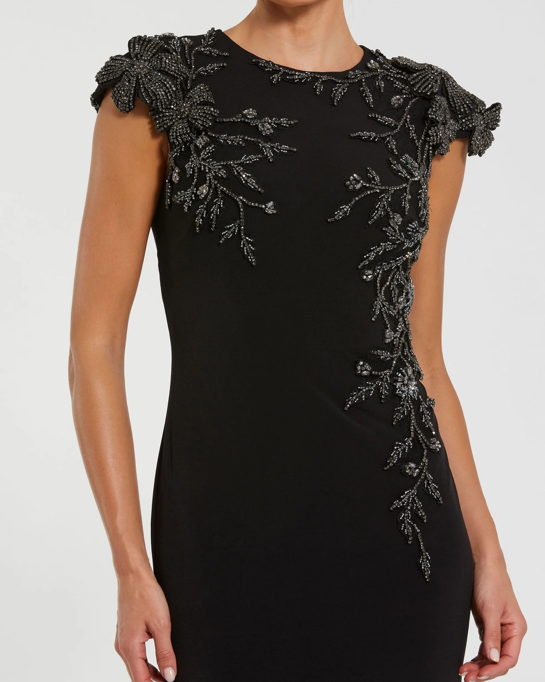 Black Cap Sleeve Jersey Column Gown With Beaded Flowers - Special Events Unlimited