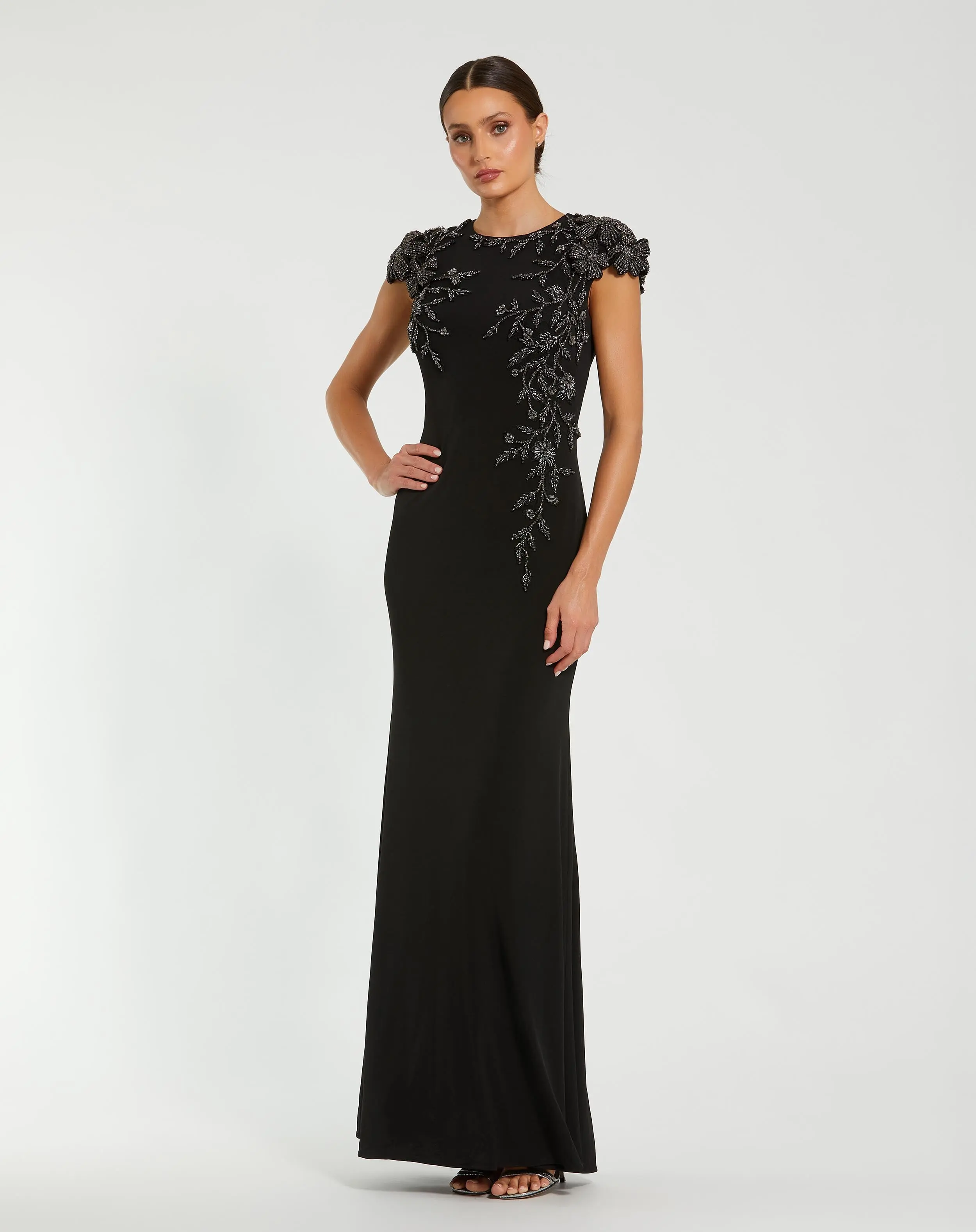 Black Cap Sleeve Jersey Column Gown With Beaded Flowers - Special Events Unlimited